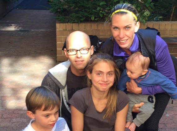 Eric in glasses taking a close family selfie with a woman and three children